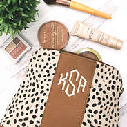 monogrammed spotted cosmetic bag with makeup
