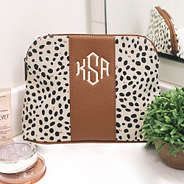monogrammed spotted cosmetic case on bathroom counter
