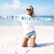 livin my best life jersey with blue letters on the beach