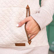 detail shot of auburn quilted pullover sweatshirt pocket