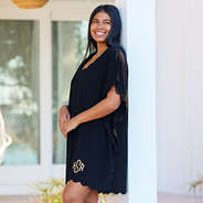 girl in black bathing suit cover up from the side