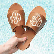 brown monogrammed summer sandals by pool
