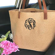 monogrammed straw tote bag in car