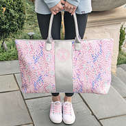 girl holding monogrammed watercolor weekender