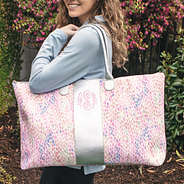 monogrammed watercolor weekender on shoulder