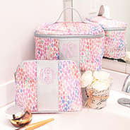 monogrammed watercolor cosmetic bags on bathroom sink