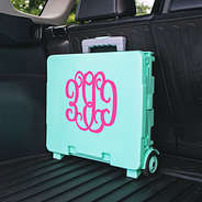 personalized rolling cart with hot pink monogram in back of car