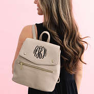 taupe grey backpack purse on shoulder
