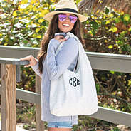 neutral leopard monogrammed hobo bag on shoulder