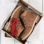 monogrammed hiking boots in box with red laces on top