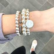 silver monogrammed ball bracelet stack on wrist