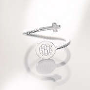 silver adjustable cross ring on glass table