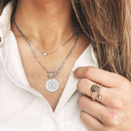 silver pendant necklace with collared shirt