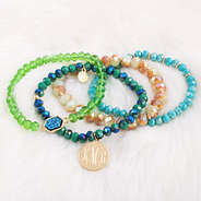 monogrammed ocean bracelet stack on fuzzy rug