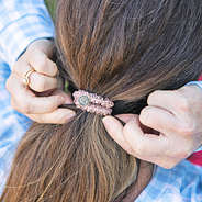 pink monogrammed hair tie in hair