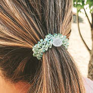 green monogrammed hair tie in hair