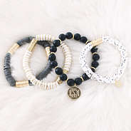 monogrammed spotted bead bracelets on fur rug