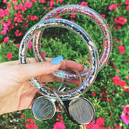 confetti key rings in hand over flowers