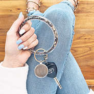 girl holding silver confetti key ring