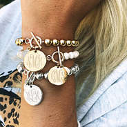 monogrammed ball bracelets on wrist