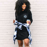 black sweater dress with monogrammed shacket tied around waist