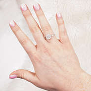 silver monogrammed audrey ring on hand in front of fuzzy rug