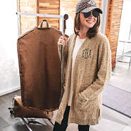 girl carrying metallic leopard garment bag on rolling rack