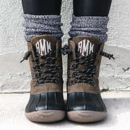 front view of brown duck boots with leggings and socks