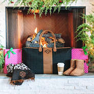 monogrammed black and brown quilted travel bag on fireplace