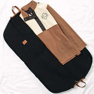 clothes inside monogrammed quilted garment bag