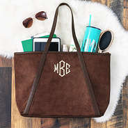 suede tote on fur rug