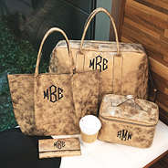 monogrammed distressed metallic travel bag collection