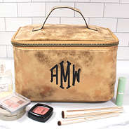 monogrammed distressed metallic train case on bathroom counter