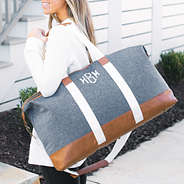 monogrammed chambray weekender on shoulder