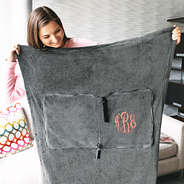 unfolded grey travel blanket with monogram
