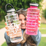 girl holding monogrammed motivational water bottles