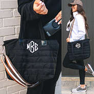 monogrammed quilted crossbody bag on arm and shoulder