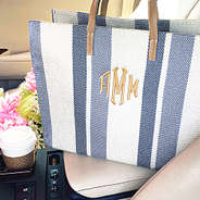 monogrammed striped handbag in car flowers