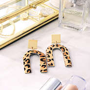 leopard print horseshoe earrings beside jewelry box