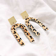 leopard horseshoe earrings on white sheet