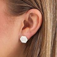 monogrammed hexagon earrings in silver on ear