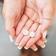 silver hexagon studs in hand