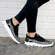 black scallop sneakers on asphalt