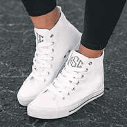 monogrammed high top canvas sneakers on asphalt