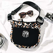 black brown crossbody with sunglasses and camera