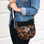 girl wearing hickory leopard crossbody with denim jacket