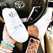 white slide on sneakers with white grommets in car - 2024