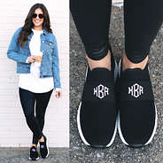 monogrammed slip on sneakers styled with leggings and denim jacket