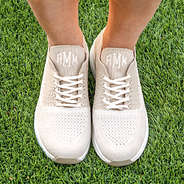 monogrammed tennis shoes in grass