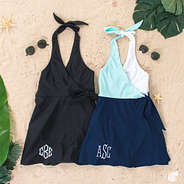 monogrammed swim dress in black and mint and navy colorblock on sand